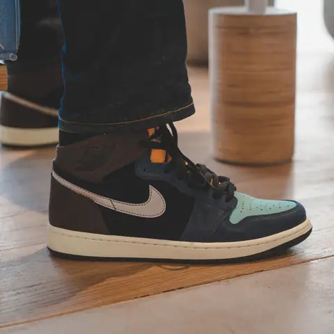 Close-up of fashionable Air Jordan sneakers on a wooden floor, capturing a trendy urban look.